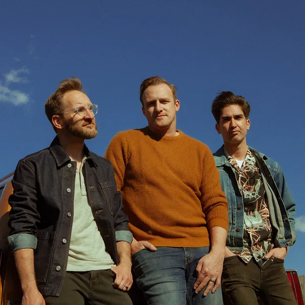 The three members of Sanctus Real with a blue sky.